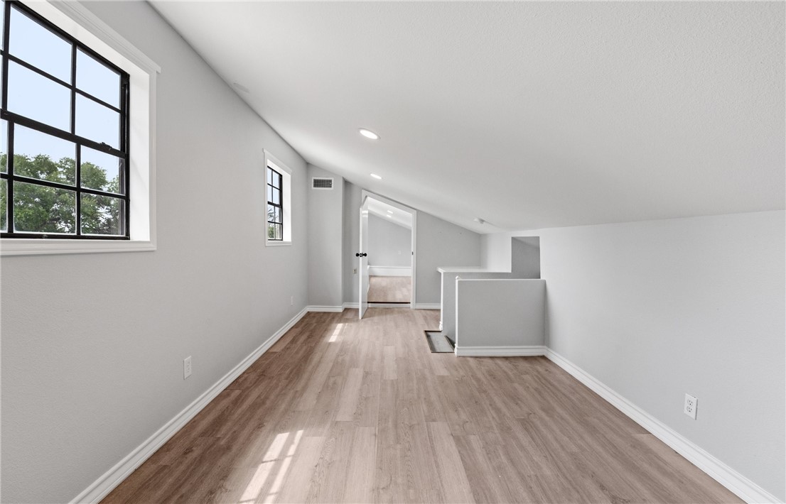 1333 Prince Drive Corpus Christi, TX 78412 - Photo 17 of 20 wooden floor in an empty room with a window
