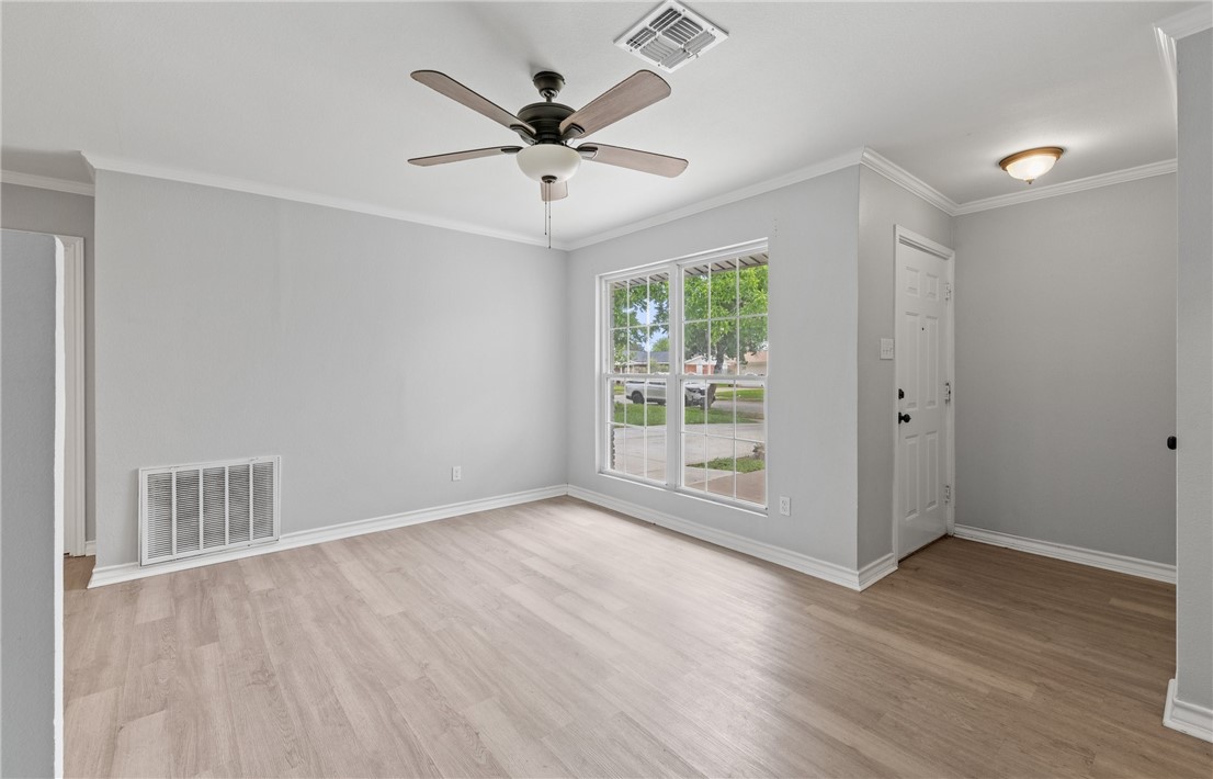 1333 Prince Drive Corpus Christi, TX 78412 - Photo 2 of 20 an empty room with wooden floor and windows