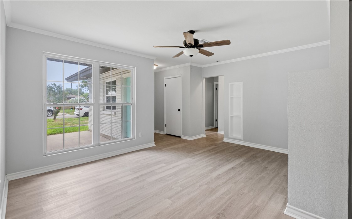 1333 Prince Drive Corpus Christi, TX 78412 - Photo 3 of 20 wooden floor in an empty room with a window