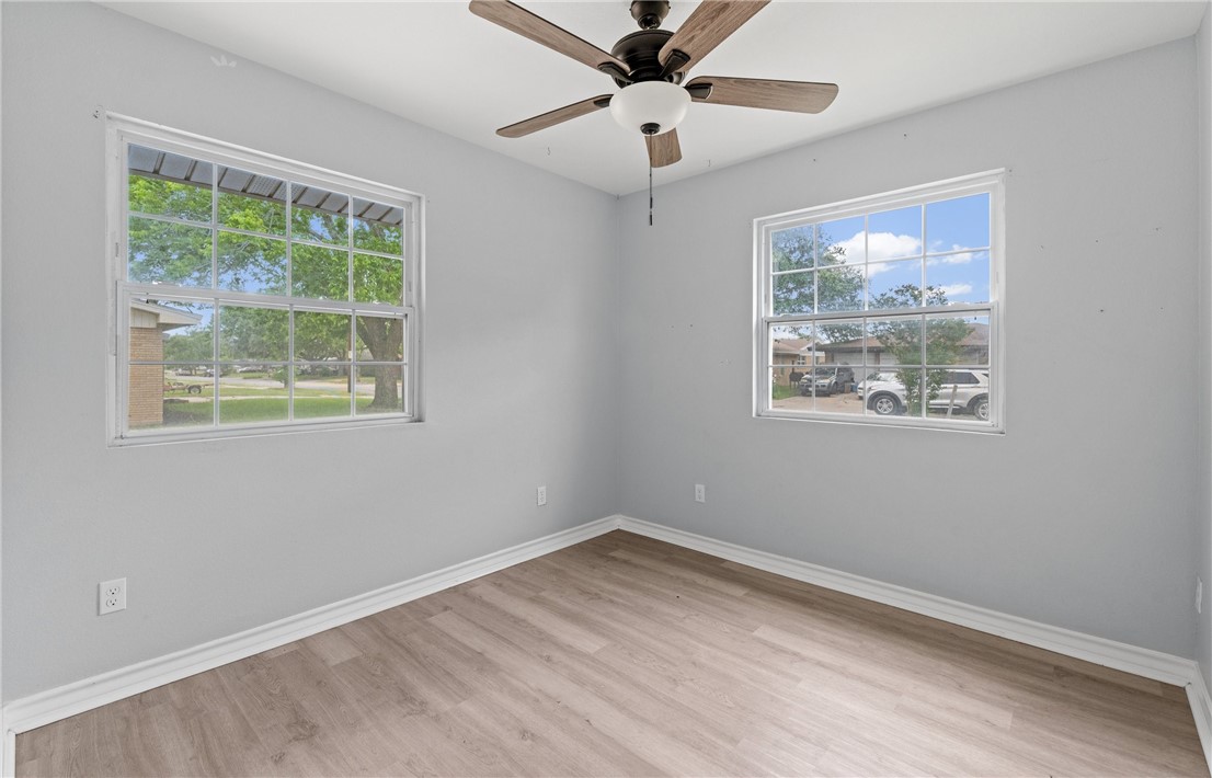 1333 Prince Drive Corpus Christi, TX 78412 - Photo 10 of 20 a view of empty room with wooden floor and fan