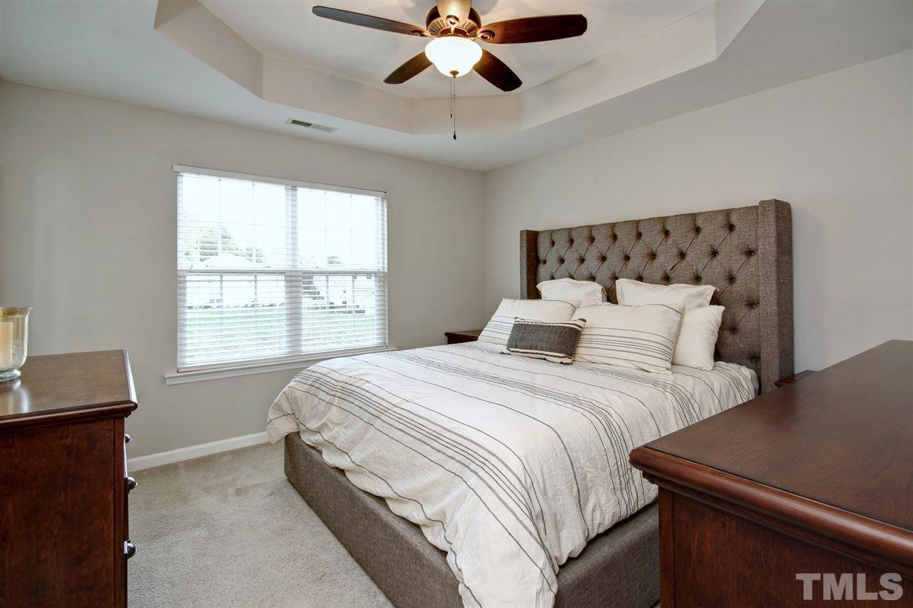 927 Ileagnes Road Raleigh, NC 27603 - Photo 12 of 26 a bedroom with bed and window with chandelier
