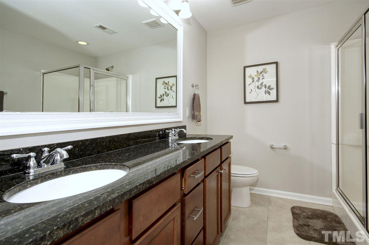 927 Ileagnes Road Raleigh, NC 27603 - Photo 14 of 26 a bathroom with a granite countertop double vanity sink and a mirror
