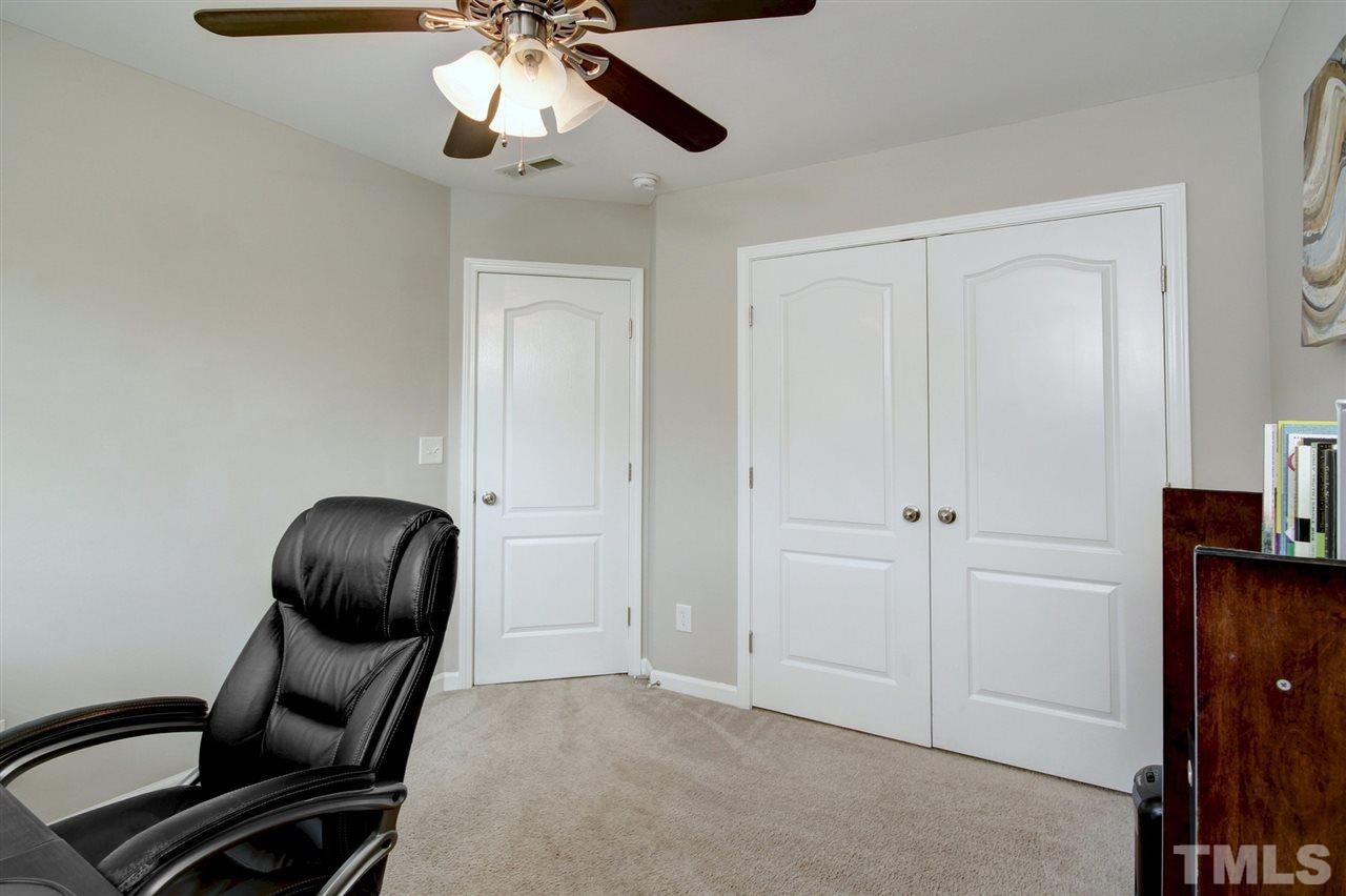 927 Ileagnes Road Raleigh, NC 27603 - Photo 18 of 26 a room with a chair and a fan