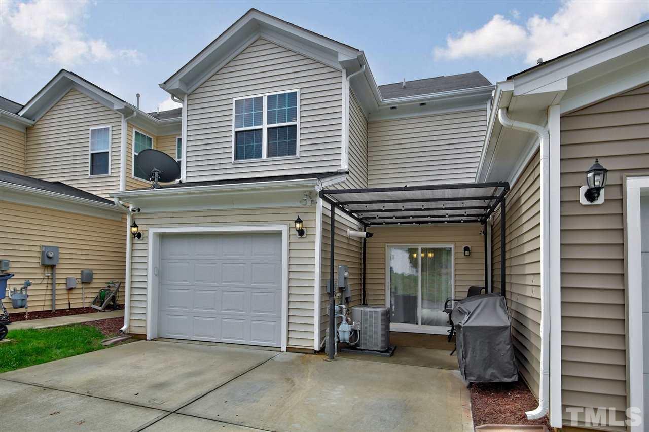 927 Ileagnes Road Raleigh, NC 27603 - Photo 20 of 26 a view of a house with a barbeque and chair and a large window