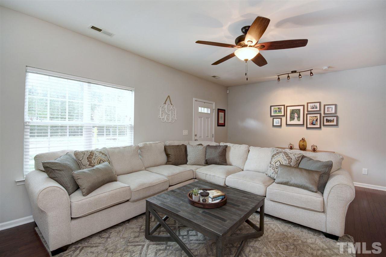 927 Ileagnes Road Raleigh, NC 27603 - Photo 3 of 26 a living room with furniture a ceiling fan and a window