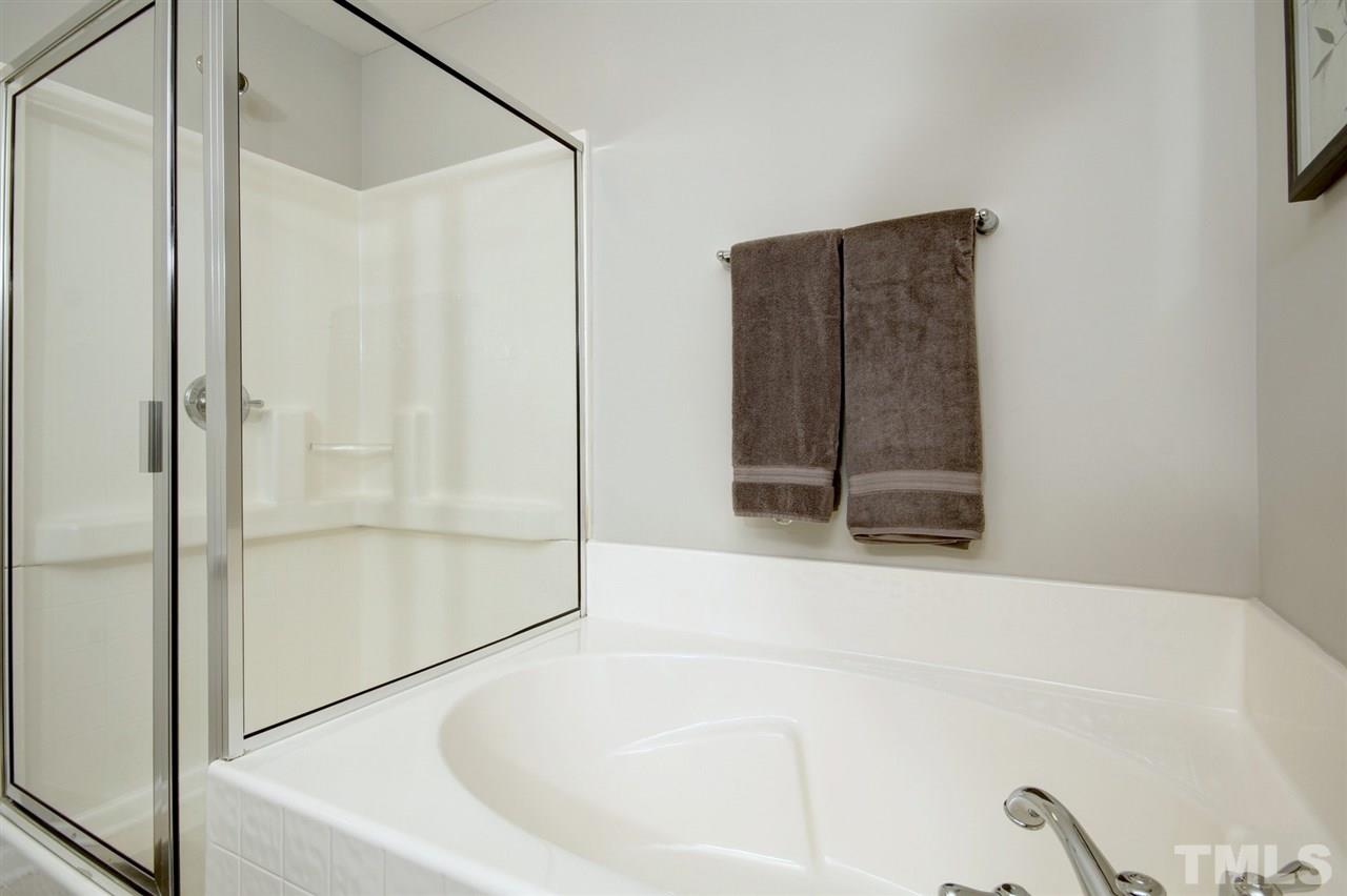 927 Ileagnes Road Raleigh, NC 27603 - Photo 25 of 26 a bathroom with a bathtub and a shower