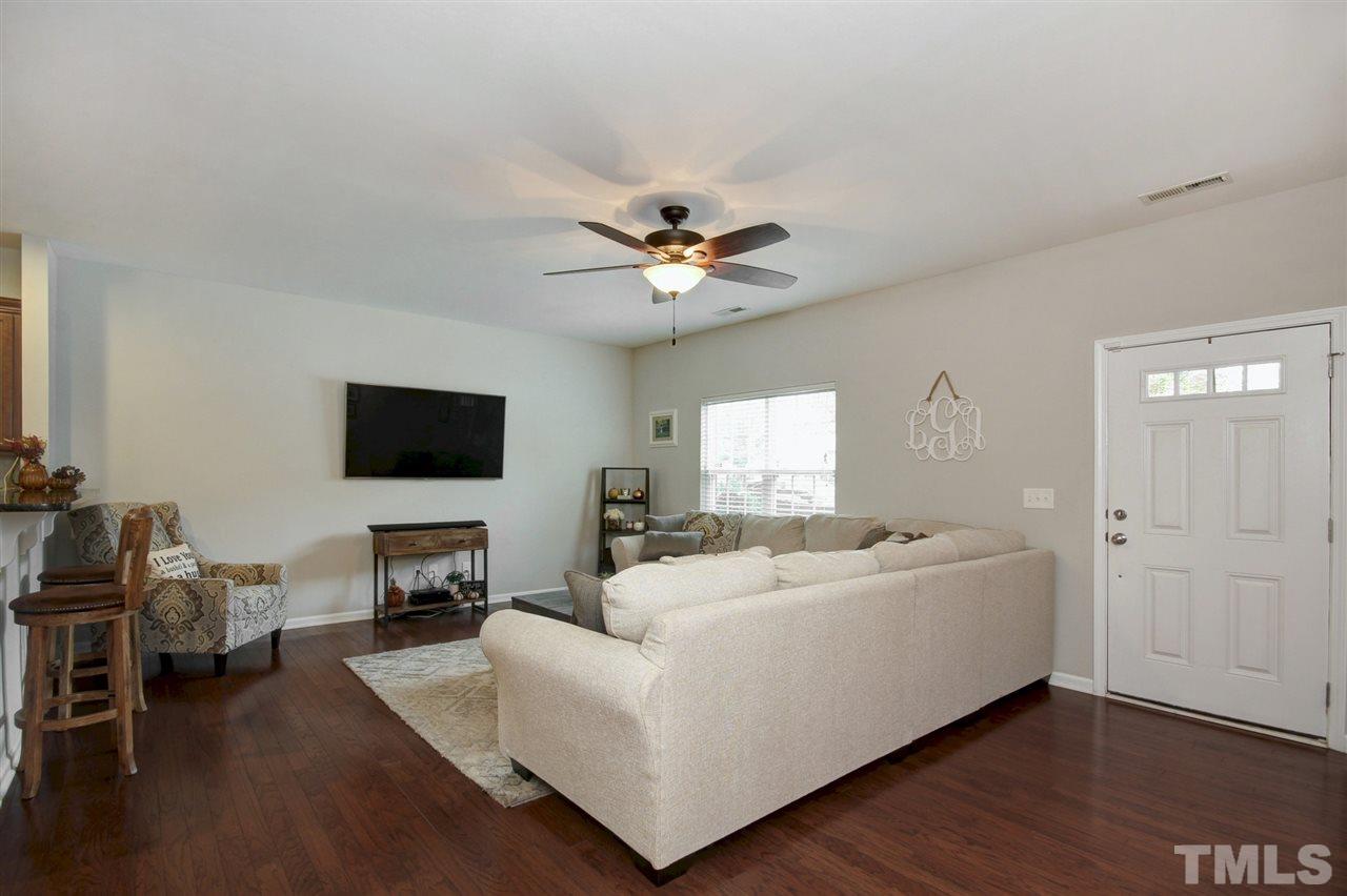 927 Ileagnes Road Raleigh, NC 27603 - Photo 4 of 26 a living room with furniture and a flat screen tv
