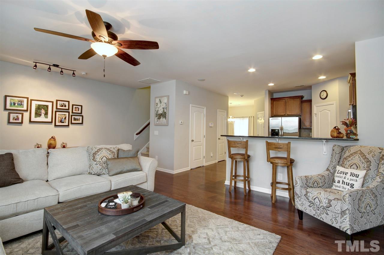 927 Ileagnes Road Raleigh, NC 27603 - Photo 6 of 26 a living room with furniture kitchen view and a wooden floor