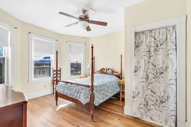 a bedroom with a bed and wooden floor