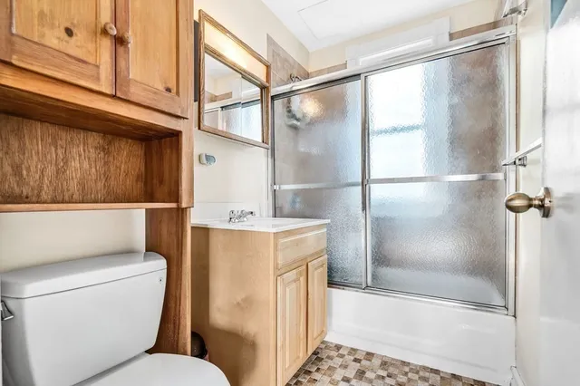 a bathroom with a toilet a sink and a shower