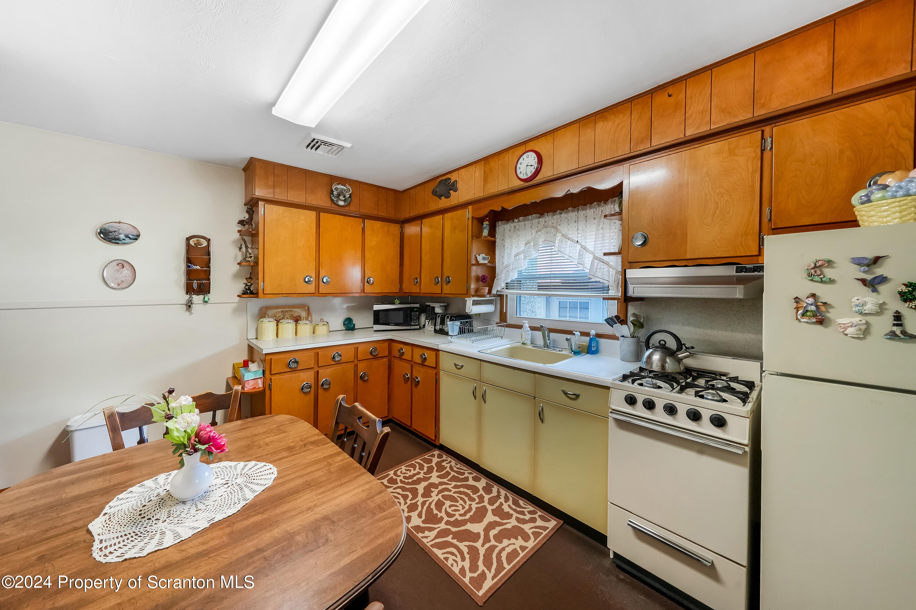 254 Hoover Street Old Forge, PA 18518 - Photo 12 of 27 a kitchen with stainless steel appliances kitchen island granite countertop a sink dishwasher stove and cabinets with wooden floor