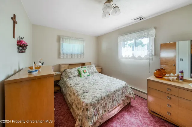 a bedroom with a bed and a dresser in it