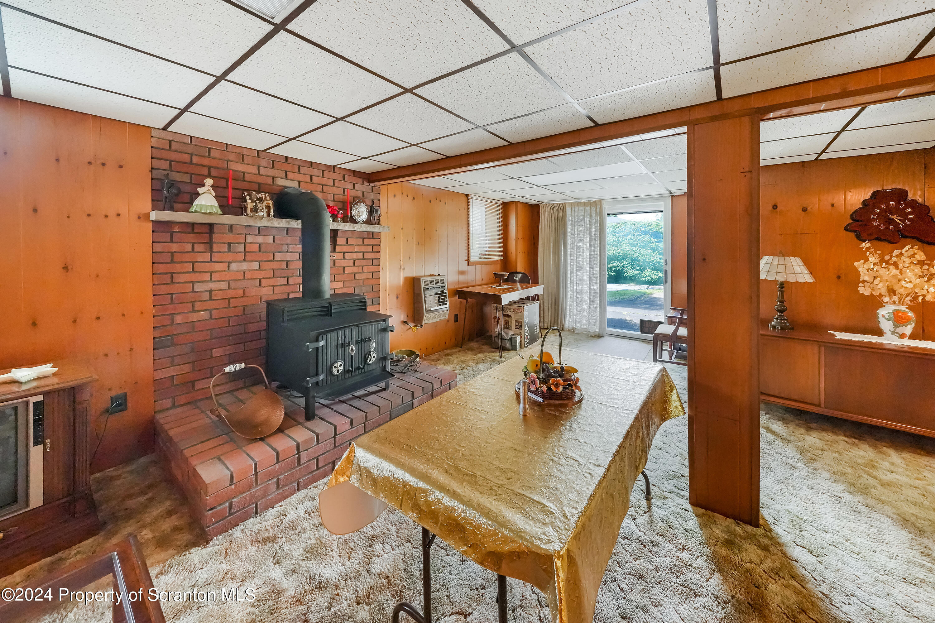 254 Hoover Street Old Forge, PA 18518 - Photo 22 of 27 a living room with furniture a rug and a chandelier