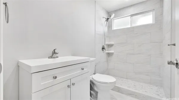 a bathroom with a sink a toilet a shower and a mirror