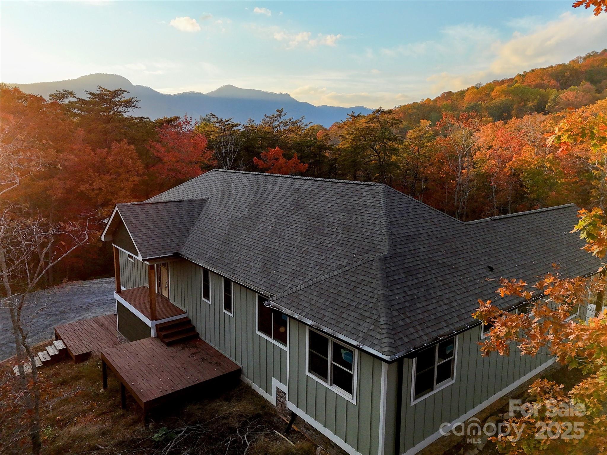 an aerial view of houses with a yard