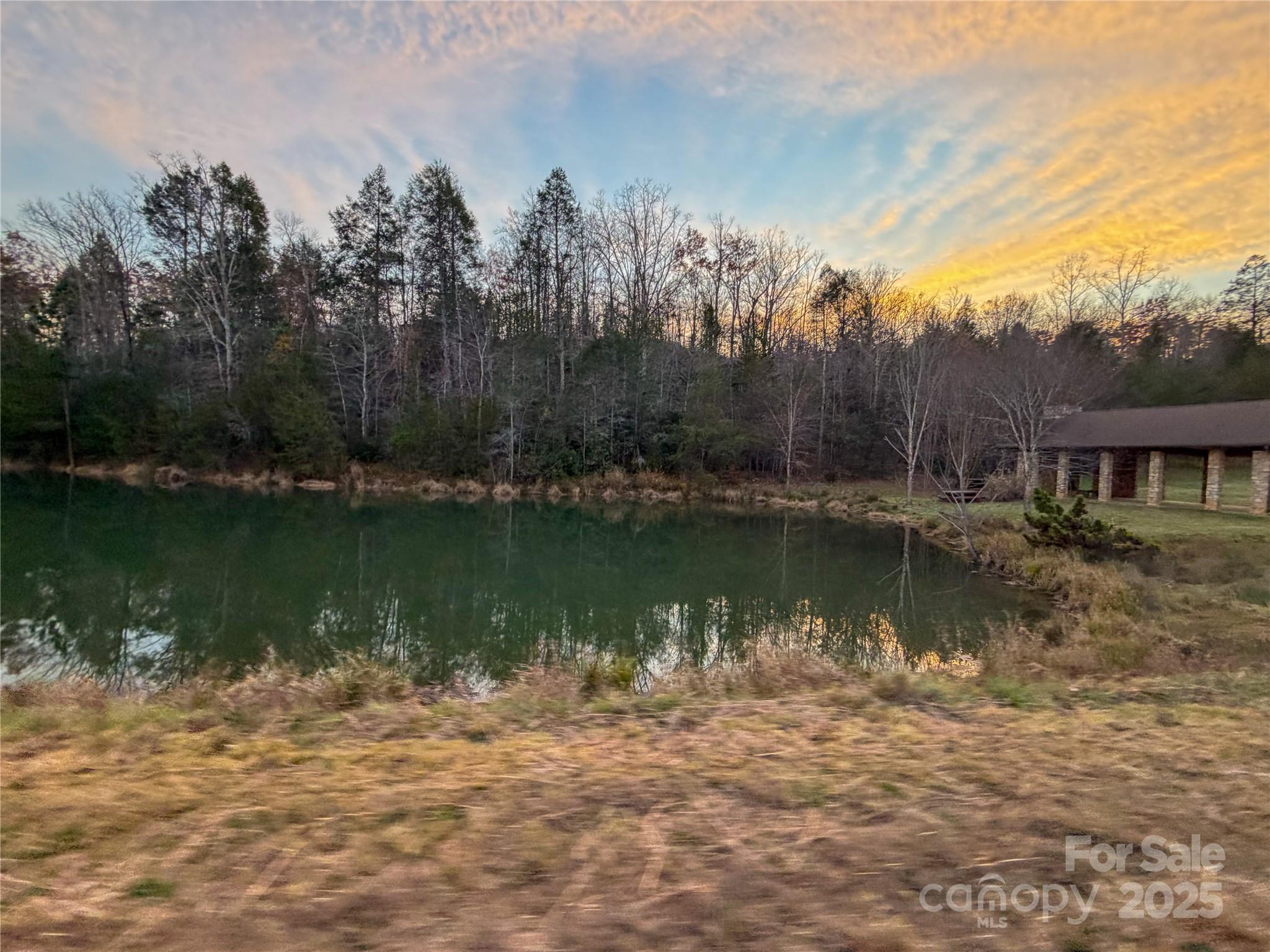 864 Matho Trace Lake Lure, NC 28746 - Photo 12 of 47 a view of a lake with a house in the background