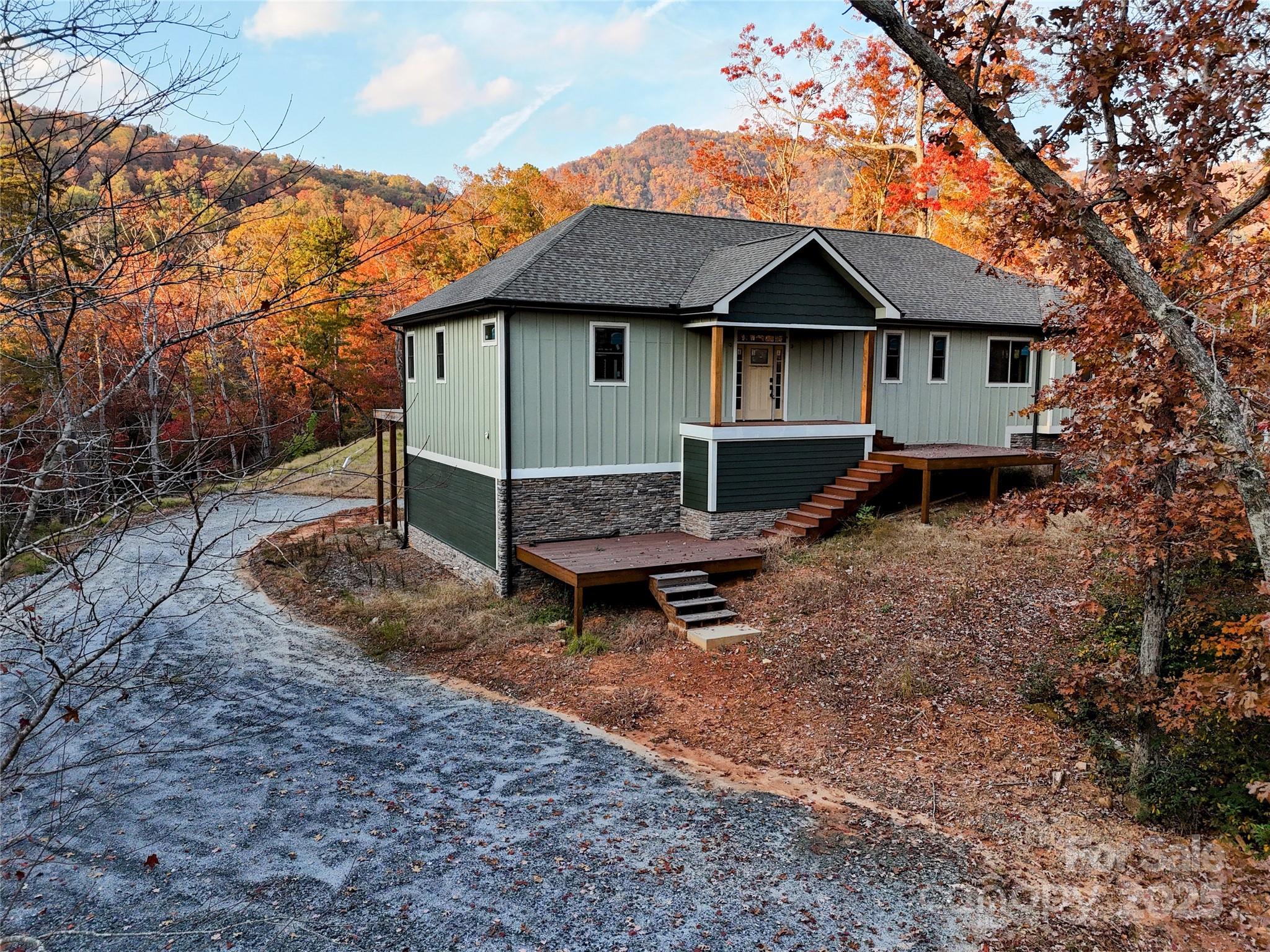 864 Matho Trace Lake Lure, NC 28746 - Photo 16 of 47 a view of house with a yard and wooden fence