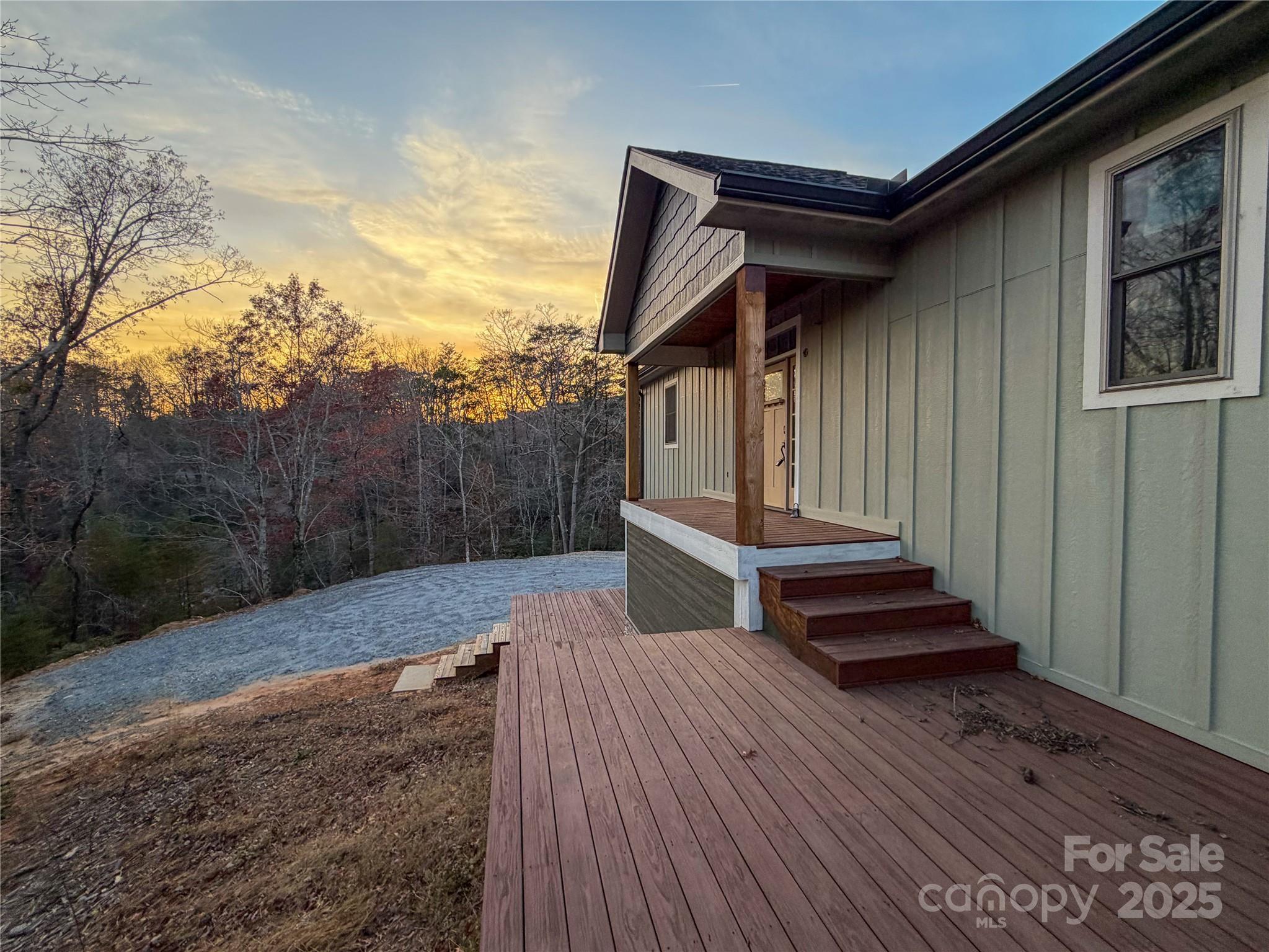 864 Matho Trace Lake Lure, NC 28746 - Photo 17 of 47 a view of a house with backyard and wooden fence
