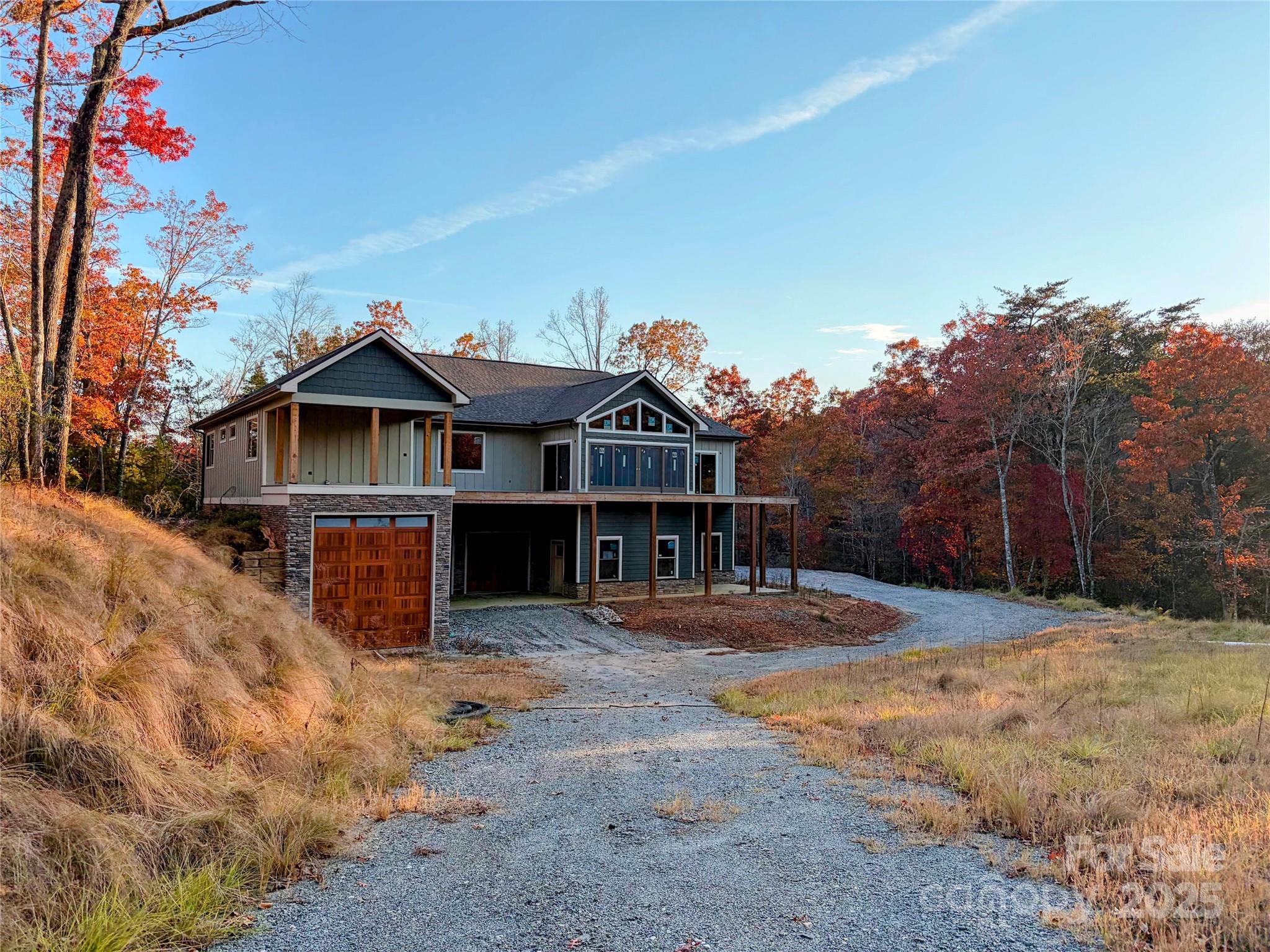 864 Matho Trace Lake Lure, NC 28746 - Photo 25 of 47 a front view of a house with a yard