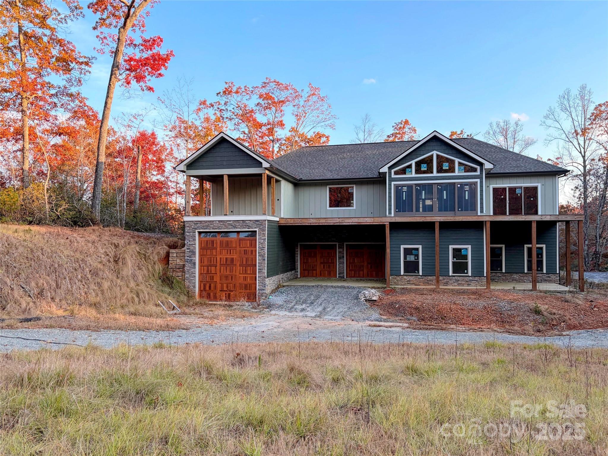 864 Matho Trace Lake Lure, NC 28746 - Photo 26 of 47 a front view of a house with a yard
