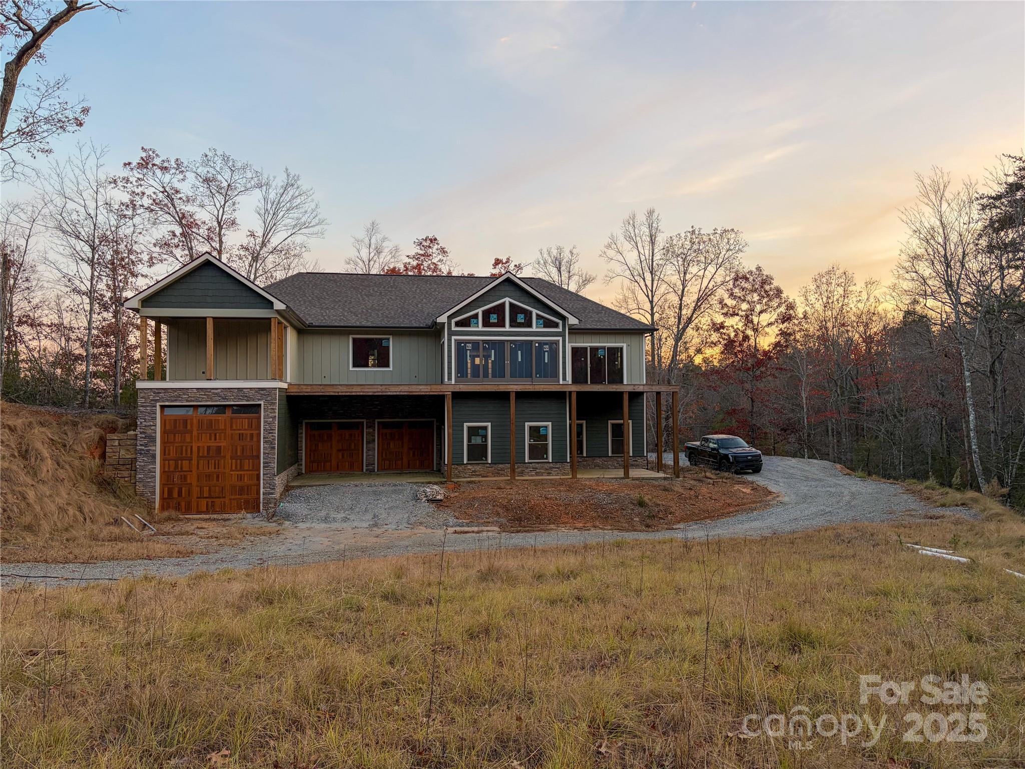 864 Matho Trace Lake Lure, NC 28746 - Photo 45 of 47 a view of a house with a yard and large trees