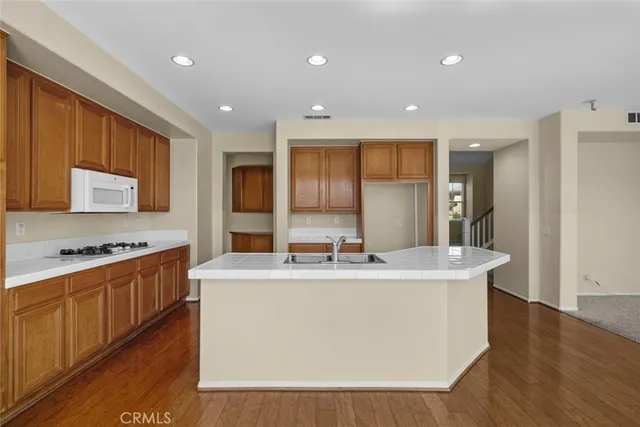 a large kitchen with stainless steel appliances granite countertop a large counter top a stove and a refrigerator
