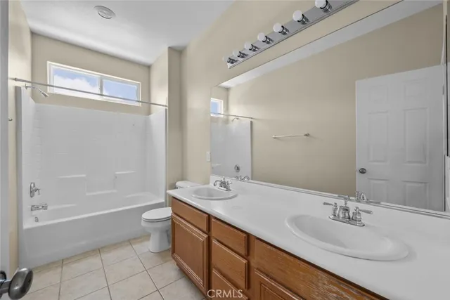 a bathroom with a double vanity sink mirror and bathtub