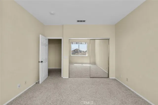 an empty room with closet and garage