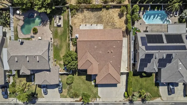 an aerial view of multiple houses with a yard