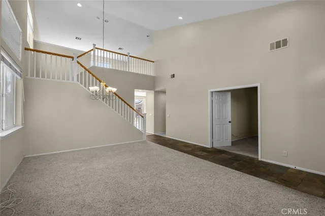 a view of an empty room with stairs