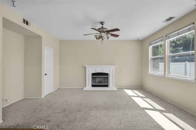 a view of a livingroom with a fireplace and a window