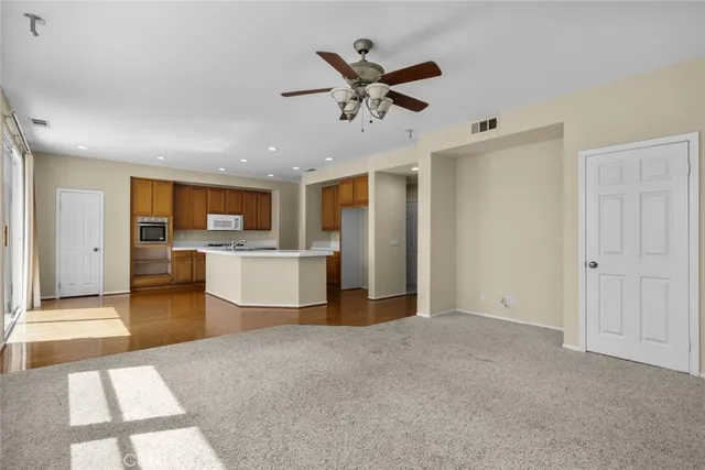 a view of a kitchen with a sink and a refrigerator