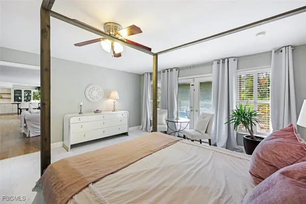 a bedroom with a bed mirror and window