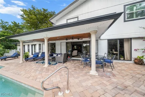 a view of a house with backyard porch and sitting area