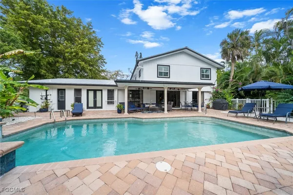 a view of a house with swimming pool and a yard