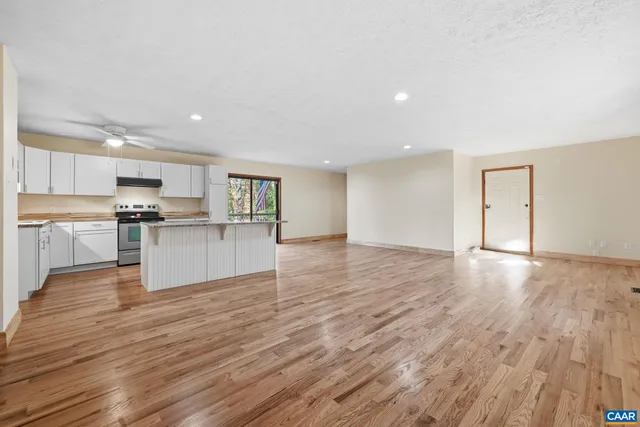 a kitchen with stainless steel appliances a refrigerator and a stove top oven
