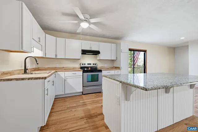 a stove top oven sitting inside of a kitchen