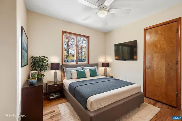 a bedroom with a large bed and a chandelier