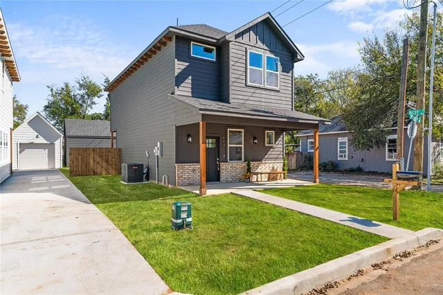 a front view of a house with a yard table and chairs