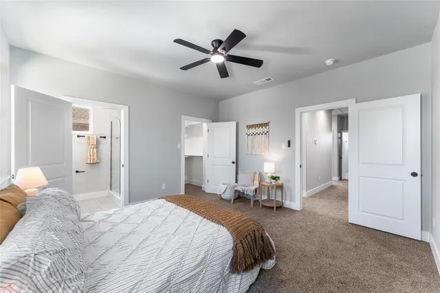 a bedroom with a bed and a large mirror