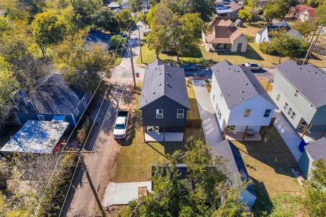 an aerial view of a house with a yard