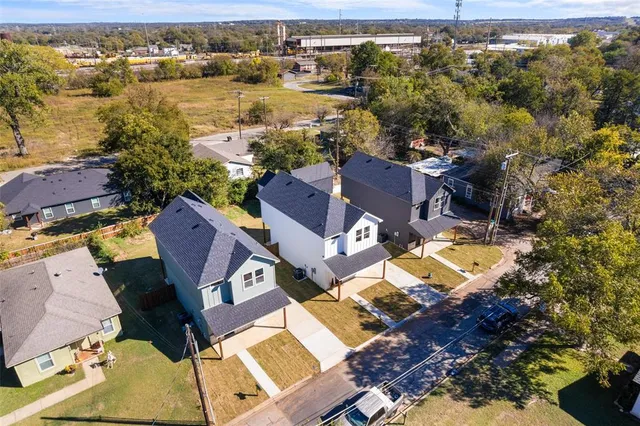 an aerial view of residential houses with outdoor space