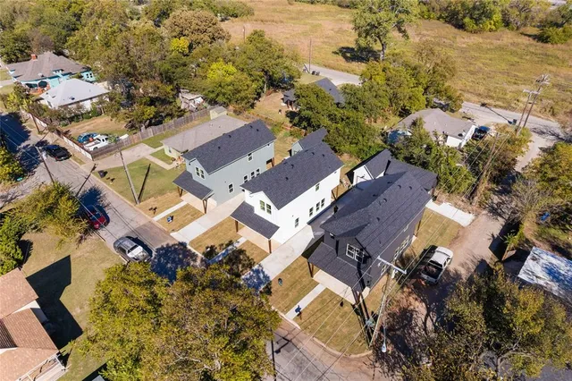 an aerial view of a residential houses with outdoor space