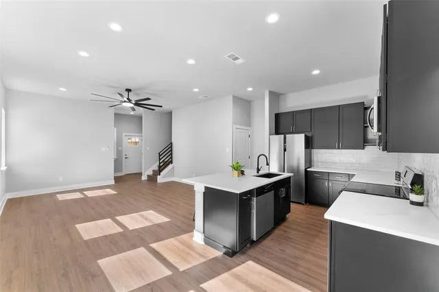 a kitchen with sink and refrigerator