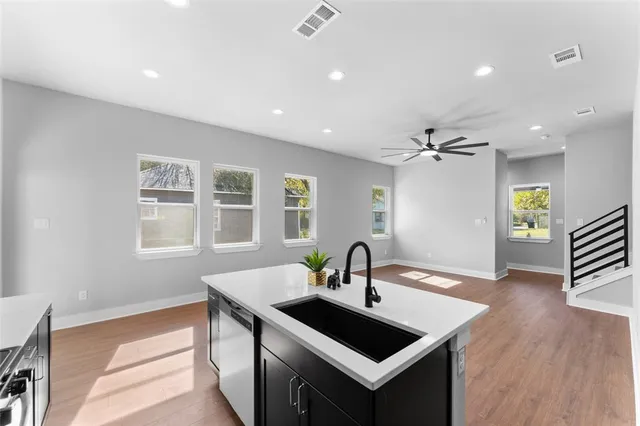 a kitchen with a sink appliances and a window