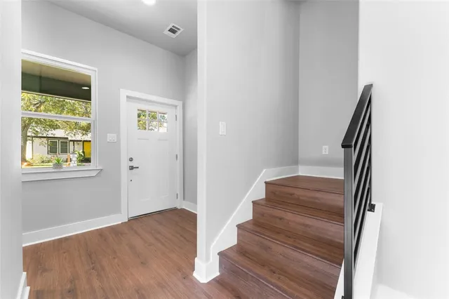 a view of entryway with wooden floor and window