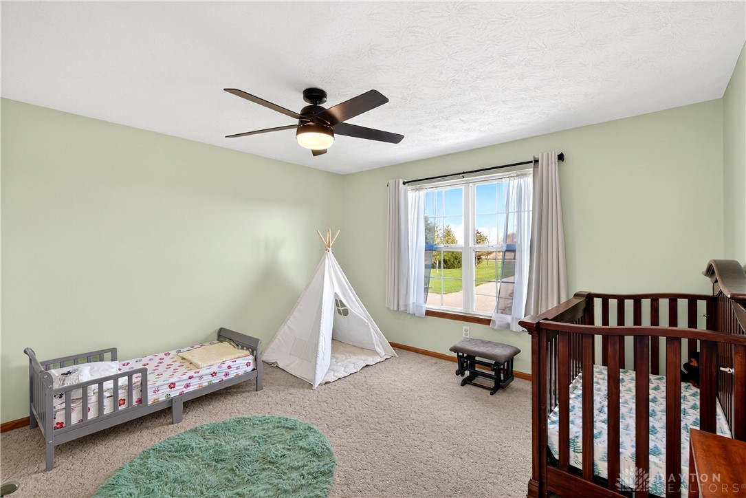 6560 Snyder Road Fletcher, OH 45326 - Photo 36 of 71 This bright and airy bedroom features soft lighting and plush carpeting, perfect for relaxation.