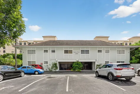 a view of a cars park in front of a house