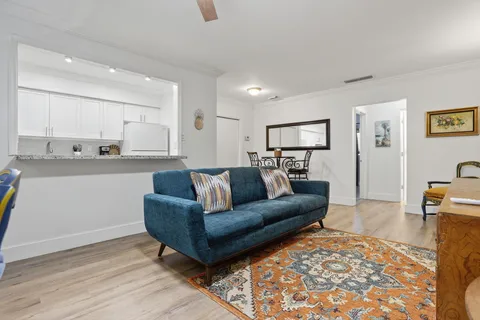 a view of a living room kitchen and a wooden floor