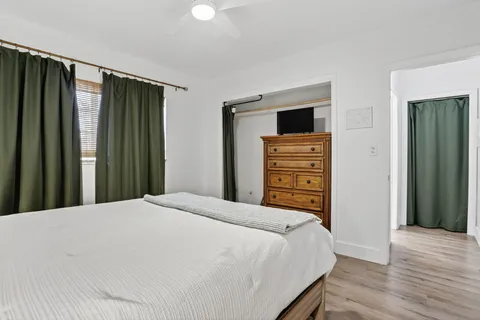 a bedroom with a bed and a dresser